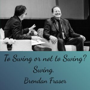 Photo of Brendan Fraser laughing during an interview with the quote, "To swing or not to swing? Swing."